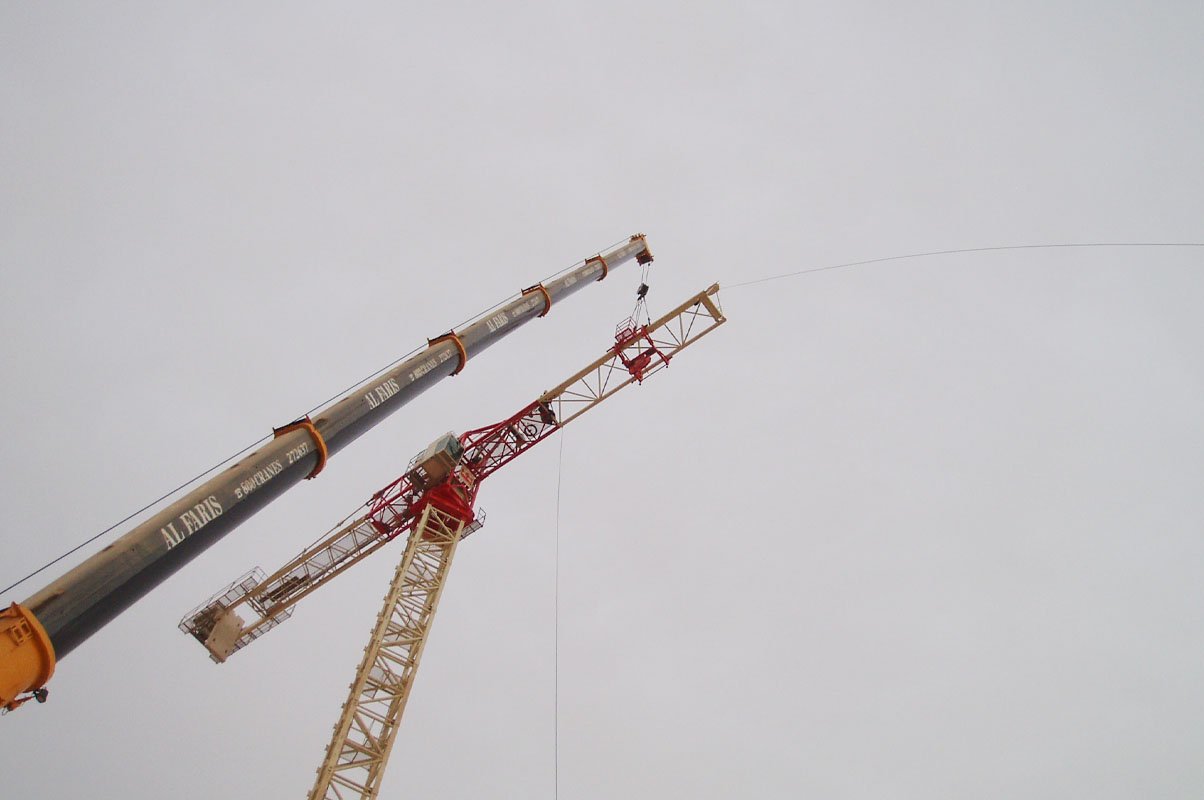 Mechanical crane parts and rotating-unit components handled during spare parts servicing.